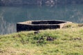 Concrete foundation left from damaged and destroyed old Second world war concrete bunker on local river bank Royalty Free Stock Photo