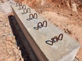 Concrete foundations with metal reinforcement extensions in the trench