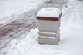 Concrete garbage can covered in snow Royalty Free Stock Photo