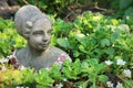 Concrete garden decor bust of woman between plants