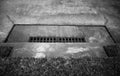 Concrete Surrounding an Iron Grate of a Storm Drain