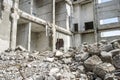 Concrete gray debris close-up against the remains of the destroyed structure of the building. Background