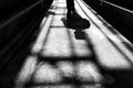 Concrete ground with a shadow of metallic stairs and a man coming forward