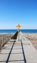 A concrete groyne reaches out into a blue sea Royalty Free Stock Photo