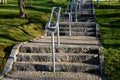 Concrete long staircase with long and short pieces of stairs and ramps made of cobblestone granite paving blocks. packing short ga