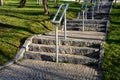 Concrete long staircase with long and short pieces of stairs and ramps made of cobblestone granite paving blocks. packing short ga