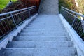 Concrete long staircase with long and short pieces of stairs and ramps made of cobblestone granite paving blocks. packing short ga