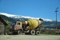 Concrete mixer on the background of beautiful mountains