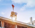 Concrete mixer and crane hook lifting container in construction site Royalty Free Stock Photo