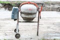 Concrete mixer is left after working time at construction site on the street. Royalty Free Stock Photo