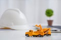 Concrete mixer truck and excavator on architect`s desk, Engineering objects, Construction site