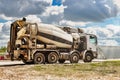 Concrete mixer truck in front of a concrete batching plant, cement factory. Loading concrete mixer truck. Close-up. Delivery of Royalty Free Stock Photo