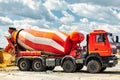 Concrete mixer truck in front of a concrete batching plant, cement factory. Loading concrete mixer truck. Close-up. Delivery of Royalty Free Stock Photo