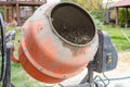 A concrete mixer with wet cement is operating outdoors highlighting the process of construction work and the preparation of Royalty Free Stock Photo