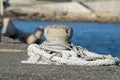 Concrete mooring bollard at a dock. with ropes around Royalty Free Stock Photo