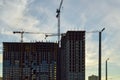 A concrete multi-storey building is being built in the city center. the builders have inserted many windows, the house stands next