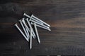 Concrete nails on a black wooden table Royalty Free Stock Photo