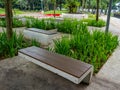 A Concrete Park Bench with Wooden Sitting Pad Royalty Free Stock Photo