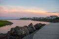 A Concrete Path With an Orange and Blue Sunset Sky Behind It at the North Wildwood Sea Wall in New Jersey Royalty Free Stock Photo