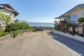 Concrete pathway heading to the gate exit with garden beds on the side in San Clemente, California