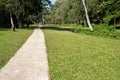Long concrete pavement in public park with grass lawn yard Royalty Free Stock Photo