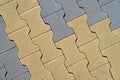 Concrete paving blocks arranged in repeating zigzag pattern with alternating color segments, pavement surface. Natural background Royalty Free Stock Photo