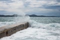 Concrete pier with a crashing wave in Zadar Croatia view at medieterranean sea Royalty Free Stock Photo