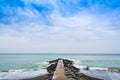 Concrete pier or jetty on seascape with cloudy blue sky in Levanto, Italy