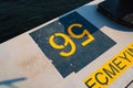 Concrete pier with yellow designations close up photo