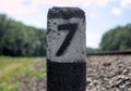 concrete pillar near the railroad with the number seven