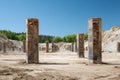 Concrete pillars stand in rows at an abandoned construction site with sand and excavation Royalty Free Stock Photo