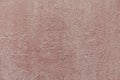 Concrete pink wall background with detailed texture. A plaster painted surface with cracks and damages. Royalty Free Stock Photo