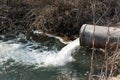 Concrete pipe transporting the poluted river Royalty Free Stock Photo