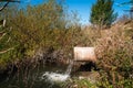 Concrete pipe transporting the poluted river Royalty Free Stock Photo