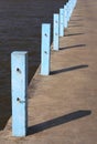 Concrete pole with chains hooks on jetty, Blue Jetty pole, Blue concrete pier pillars Royalty Free Stock Photo