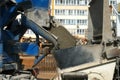 Concrete pouring from a concrete mixer in metal container on construction site. Royalty Free Stock Photo