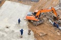 Workers smoothing concrete by trowel to finish concrete floor on construction site Royalty Free Stock Photo