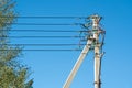 Concrete Power Line Post, underground power cable goes into overhead line. The first pillar in a chain of concrete supports Royalty Free Stock Photo