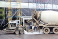 concrete pump and mixer to work together pouring cement floors in the shopping center for repair.