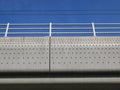 concrete railroadbridge with a dot pattern against a blue sky Royalty Free Stock Photo