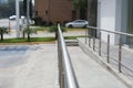 Concrete ramp with metal handrail near building outdoors, closeup