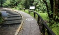 Concrete ramp way with wooden handrails and disabled sign for support wheelchair disabled people in the park Royalty Free Stock Photo