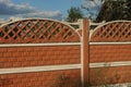 Concrete red brown fence on a rural street