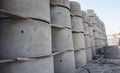 Concrete ring wells with different diameters and gray lie in the street