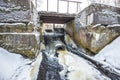 Concrete river dam with non-freezing water stream in winter Royalty Free Stock Photo