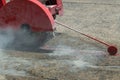 Concrete Road Cutters with worker. Worker using diamond saw blade machine cutting concrete road at construction site. Concrete cut Royalty Free Stock Photo