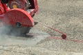 Concrete Road Cutters with worker. Worker using diamond saw blade machine cutting concrete road at construction site. Concrete cut Royalty Free Stock Photo