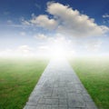 Concrete road in Grass fields and blue sky Royalty Free Stock Photo