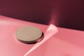 Concrete round podium in sun light with shadow on pink background. A scene with cement display show case for cosmetic