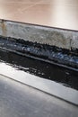 Concrete seam waterproofing with bitumen Royalty Free Stock Photo